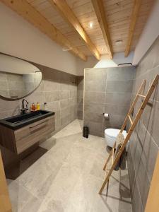 a bathroom with a sink and a toilet at Vue sur la colline La-Roche in Bouzais +14 photos