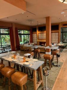 a dining room with tables and chairs and windows at Saman Hotel Boutique in Valencia +36 photos