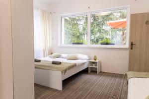 a bedroom with a bed and a window at Penzión Stálica in Bojnice +16 photos
