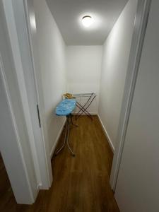 a small hallway with a table in the corner of a room at Apartmani Ivana in Prozor