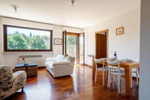 a living room with a table and a dining room at Appartamento Posta del Lago in Passignano sul Trasimeno