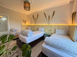a room with three beds and a couch in it at Unique Villa in Cappadocia in Ürgüp