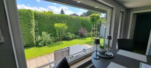 a room with a view of a garden from a window at Ferienhaus Adelon in Möhnesee