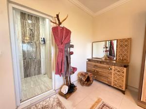 a bathroom with a shower and a dresser in a room at Unique Villa in Cappadocia in Ürgüp