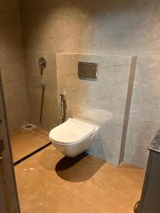 a bathroom with a toilet in a stone wall at AS Living Guest House - A boutique stay near Apollo Hospital, City Center Mall, PhysicsWallah, Allen, SPM in Guwahati