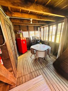 ein Zimmer mit einem Tisch auf einer Holzterrasse in der Unterkunft Cabañas Tlacult Gatü in Tepoztlán