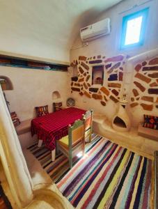 a living room with a table and a room with a rug at Chambre d'hôtes medenine in Medenine +19 photos