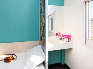 a bathroom with a white tub and a sink at hotelF1 Epinay sur Orge in Épinay-sur-Orge +32 photos