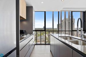 a kitchen with a view of a city at Ocean View 3 Bedroom with Great Facilities - Hosted by Gold Coast Luxury Resorts in Gold Coast