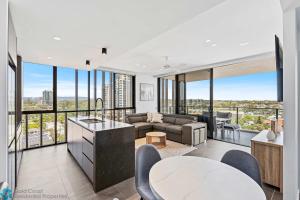 a living room with a couch and a table at Ocean View 3 Bedroom with Great Facilities - Hosted by Gold Coast Luxury Resorts in Gold Coast