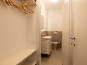 a small bathroom with a sink and a toilet at Casa Rita - Casa vacanze - free parking terrazze e giardino area barbecue TOP CLASS in Predore +37 photos