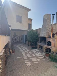 a house with a brick walkway next to a building at VENTA DE LA SISA in Sisante