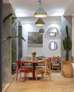 a dining room with a table and chairs at Riad Inna & Watersports Center in Essaouira