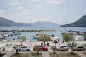 a group of cars parked at a marina with boats at NIMA Mytikas Apartments - Aitoloakarnania in Mitika
