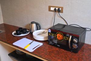 a counter with a toaster and a toaster on a table at Auro Green Villa in Pondicherry