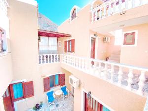 a view from the balcony of a building with blue chairs at Villa Dima in Perissa