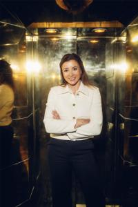 a woman standing in front of a elevator at Radisson Collection, Strand Hotel, Stockholm in Stockholm
