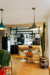 a room with a table and chairs and a kitchen at Riad Inna & Watersports Center in Essaouira +43 photos
