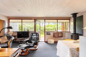 a living room with a chair and a table at 2218-Ringkobing-Milevej-22 in Klegod