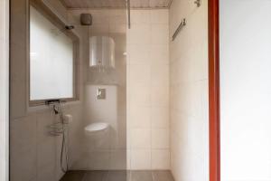a bathroom with a shower with a toilet and a window at 2218-Ringkobing-Milevej-22 in Klegod +27 photos