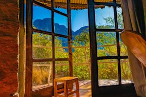 a window with a wooden stool in front of it at Tsarasoa Lodge in Ambalavao