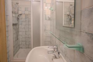 a bathroom with a sink and a bath tub at Casa Caorer by Sunhome Fiemme in Predazzo