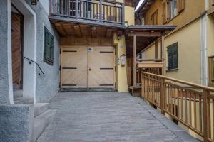 a wooden garage door in a building with a balcony at Casa Caorer by Sunhome Fiemme in Predazzo