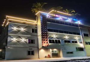 a building with lights on the side of it at Dev'S Inn Luxurious Homestays in Similigurha +10 photos