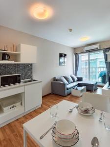 a kitchen and living room with a table and a couch at Condo in Hua Hin in Hua Hin