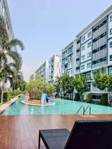 a large swimming pool in front of a building at Condo in Hua Hin in Hua Hin