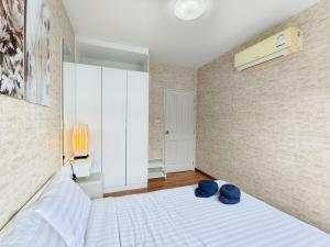 a bedroom with a bed with two blue hats on it at Condo in Hua Hin in Hua Hin