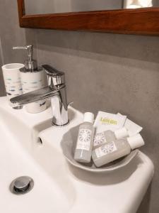 a bathroom sink with a plate of toiletries on it at Casa Gimaga in Pozzuoli +24 photos