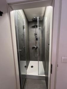 a shower with a glass door in a bathroom at Cukrarna Guest Accommodation in Kranj +80 photos
