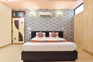 a bedroom with a large bed in a room at FabHotel Moon Stone, Near Jawahar Circle - World Trade Park in Jaipur
