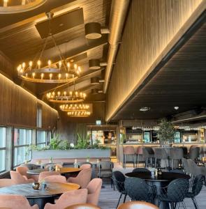 a restaurant with tables and chairs and a bar at Spidsbergseter Resort Rondane in Venabygd