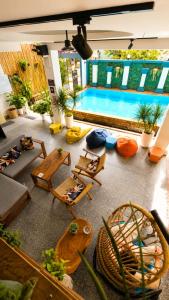 a living room with a swimming pool and chairs at LOTUS SERENITY Hostel in Siem Reap