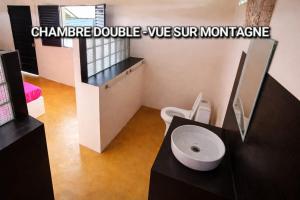a bathroom with a sink and a toilet in it at Casa Lantana in Antsiranana