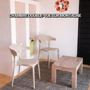 two chairs and a coffee table in a room at Casa Lantana in Antsiranana