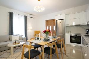 a kitchen and living room with a table and chairs at Oasis White in Durrës +21 photos