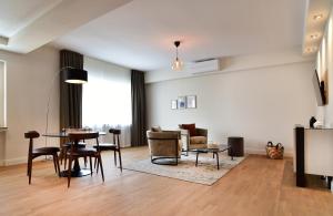 a living room with a table and a couch at SAXX Apartments Hagen in Hagen