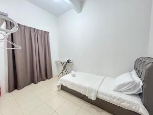 a bedroom with a bed and a curtain at FE Homestay in Tawau