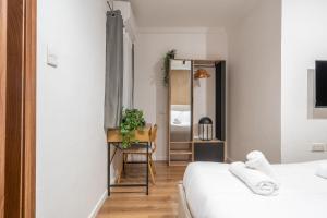 a bedroom with two beds and a chair and a mirror at Slimiza in Sliema