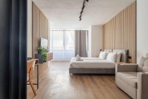 a hotel room with a bed and a couch at Slimiza in Sliema