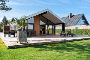 a pavilion with chairs and tables in front of a house at 30129-Odder-P-Baatrupsvej-29 in Odder