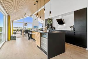a kitchen with black cabinets and a counter top at 30129-Odder-P-Baatrupsvej-29 in Odder