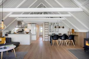 a living room with a couch and a dining room at 299-Ringkobing-Havklitvej-24 in Klegod