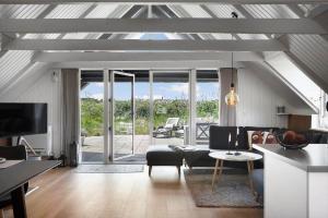 a living room with a couch and a table at 299-Ringkobing-Havklitvej-24 in Klegod