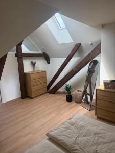 a attic room with a bed and a skylight at Loft Günni mit Whirlpool in Wietzendorf