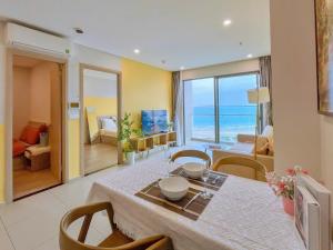 a dining room with a table and chairs and the ocean at The Song Vung Tau Apartment - Căn Hộ Du Lịch Biển Vũng Tàu in Xã Thang Tam