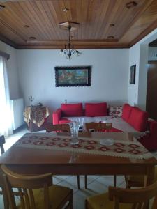 a living room with a table and a couch at Theasi in Konitsa +9 photos